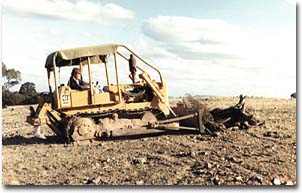 Clearing tree stumps as part of reclaming tunnelled land near Redcastle. 